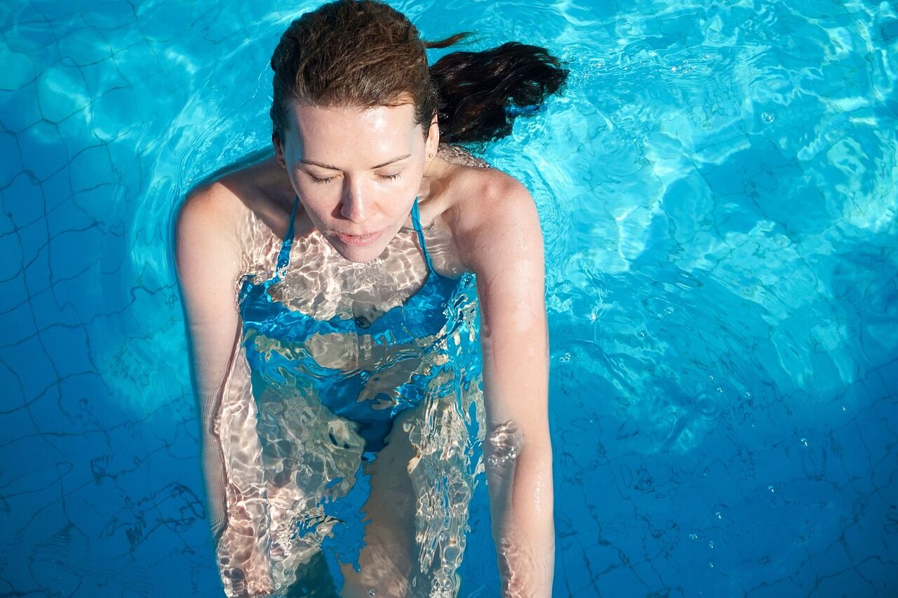A woman swims in a pool for a great day of exercise